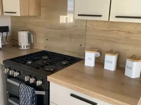 Gas hob with a kettle and tea, coffee and sugar canisters