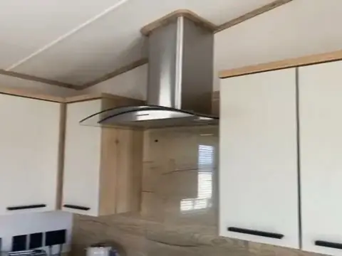 Kitchen with a stainless-steel extractor hood and cream cabinets